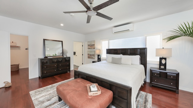 bedroom featuring dark hardwood / wood-style floors, an AC wall unit, and ceiling fan