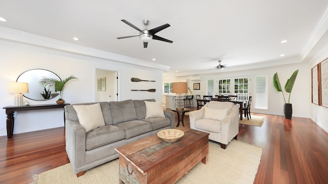 living room with wood-type flooring, ceiling fan, and ornamental molding