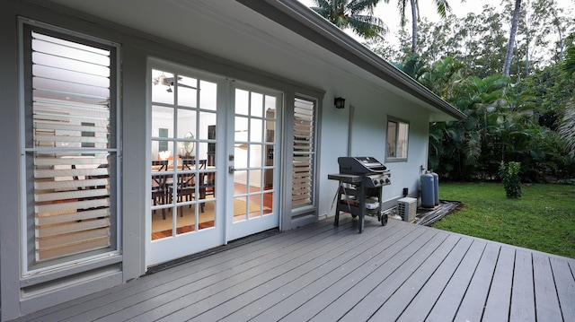 wooden deck with grilling area and a yard