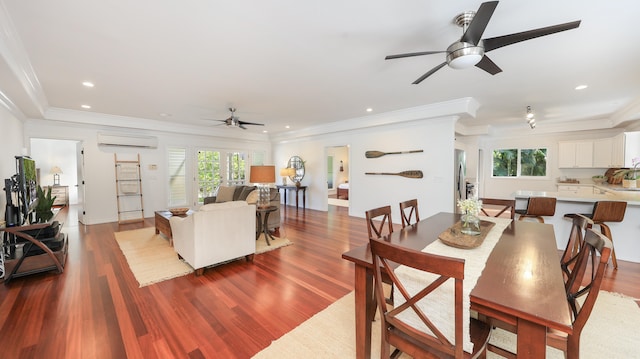 dining space featuring crown molding, hardwood / wood-style flooring, a wall unit AC, and ceiling fan