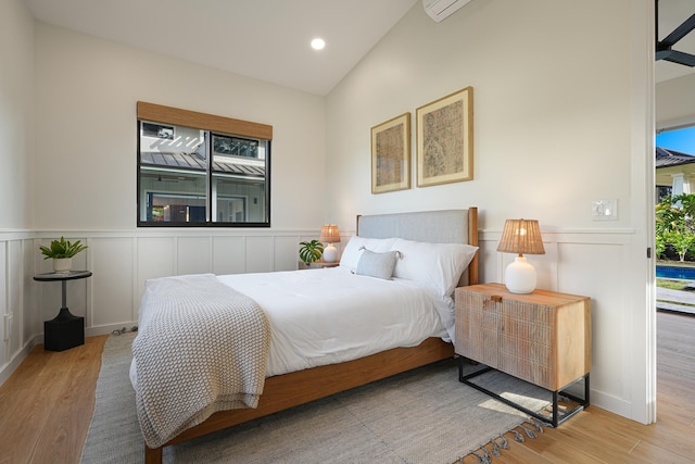 bedroom featuring light hardwood / wood-style floors and vaulted ceiling