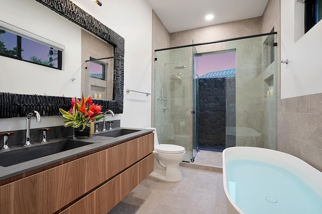 full bathroom with tile patterned flooring, vanity, toilet, and plus walk in shower