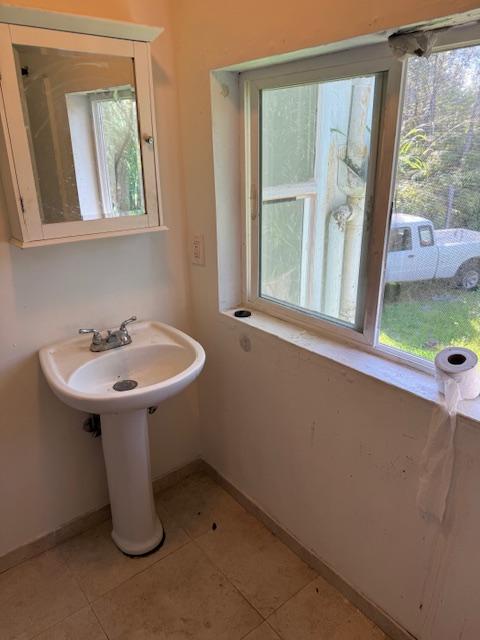 bathroom with plenty of natural light and tile patterned flooring