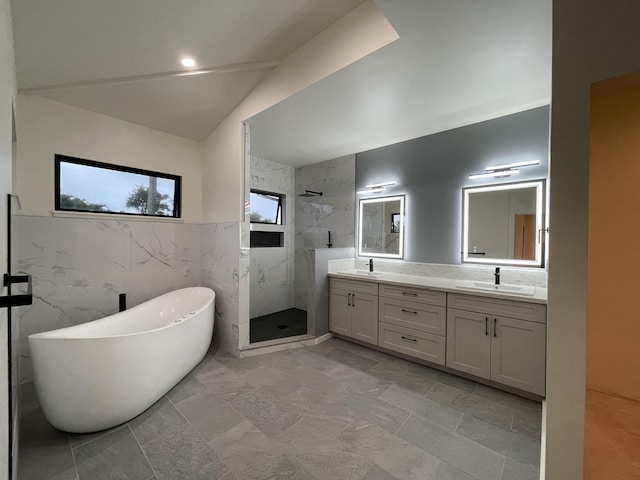 bathroom featuring vanity, shower with separate bathtub, lofted ceiling, and tile walls