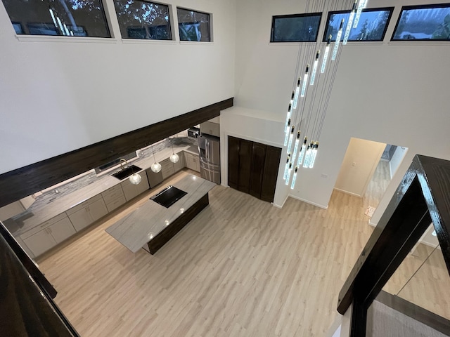 living room with sink and light hardwood / wood-style flooring