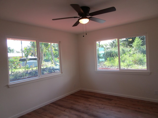 unfurnished room featuring ceiling fan and dark hardwood / wood-style flooring