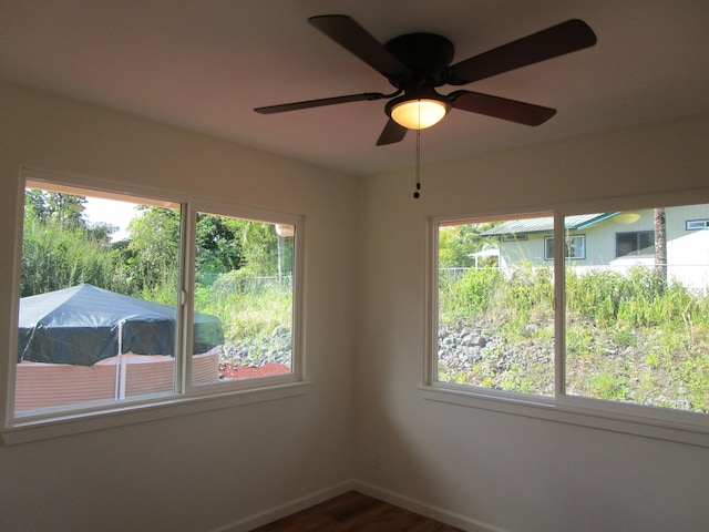 empty room with ceiling fan and wood-type flooring