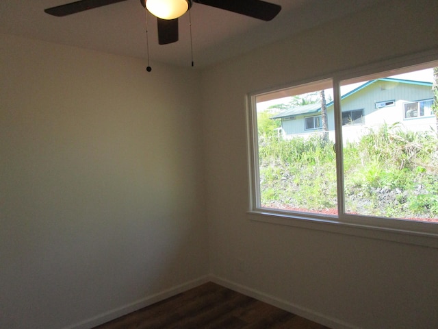 empty room featuring ceiling fan and dark hardwood / wood-style floors