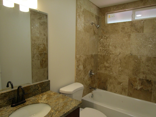 full bathroom with vanity, toilet, and tiled shower / bath