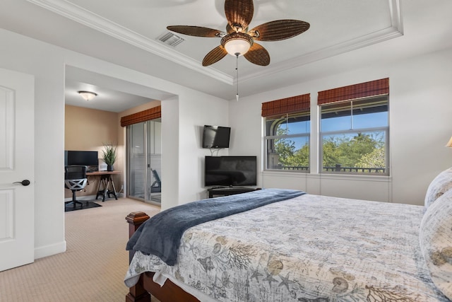 carpeted bedroom featuring ceiling fan, a raised ceiling, and ornamental molding