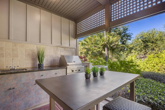 view of patio featuring grilling area, sink, and exterior kitchen