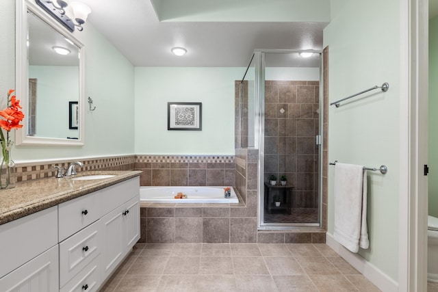 full bathroom with tile patterned flooring, vanity, separate shower and tub, and toilet