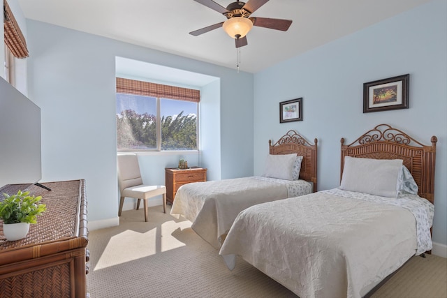 bedroom with ceiling fan and light carpet