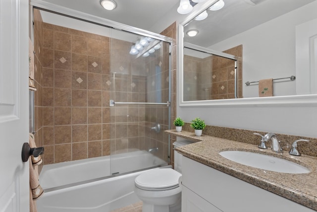 full bathroom with shower / bath combination with glass door, vanity, and toilet