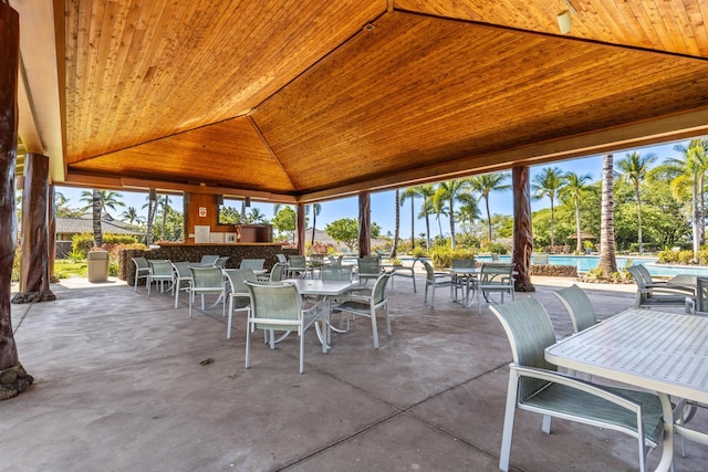 view of patio / terrace featuring exterior bar and a community pool