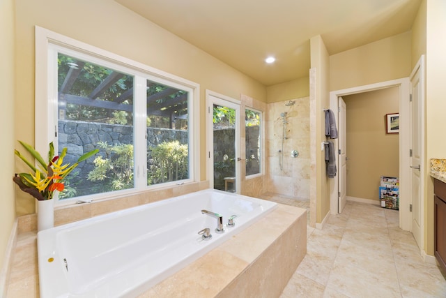 bathroom featuring tile patterned floors, vanity, and separate shower and tub