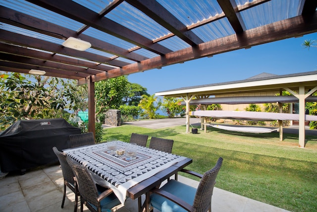 view of patio / terrace with a pergola and a grill