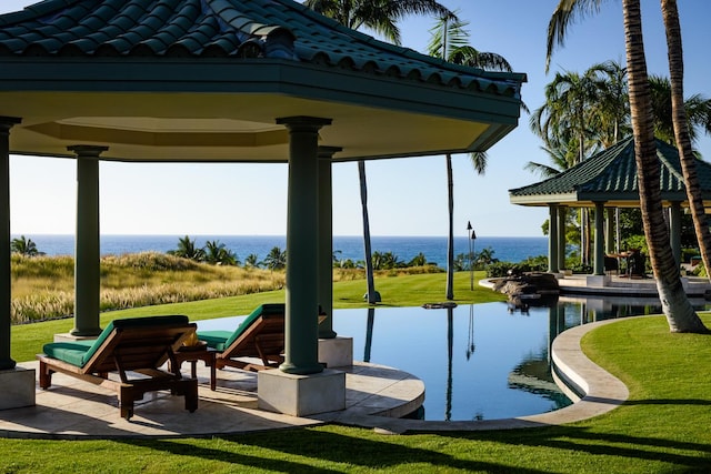 surrounding community featuring a gazebo, a lawn, and a water view