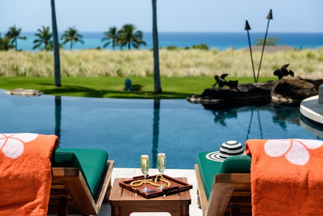 view of swimming pool featuring a water view