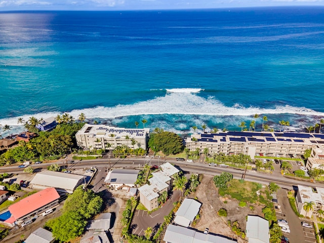 birds eye view of property with a water view and a beach view