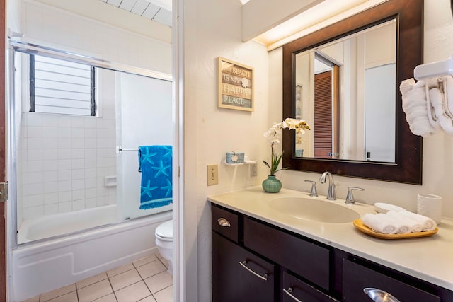 full bathroom with tile patterned floors, toilet, vanity, and combined bath / shower with glass door