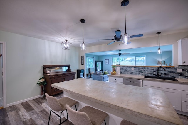 kitchen with white cabinets, dishwasher, pendant lighting, and sink