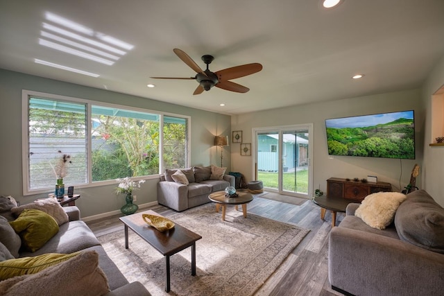 living room featuring light hardwood / wood-style flooring and ceiling fan