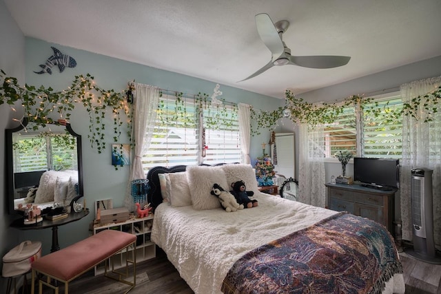 bedroom featuring hardwood / wood-style floors and ceiling fan