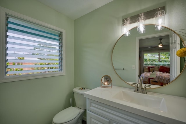 bathroom with ceiling fan, vanity, and toilet