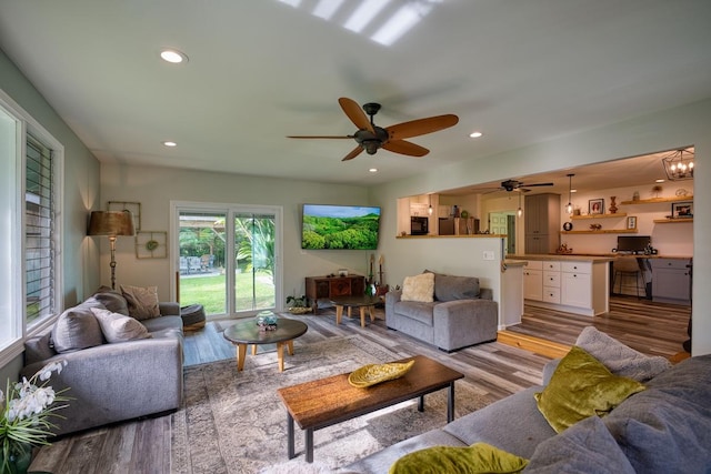 living room featuring ceiling fan and light wood-type flooring