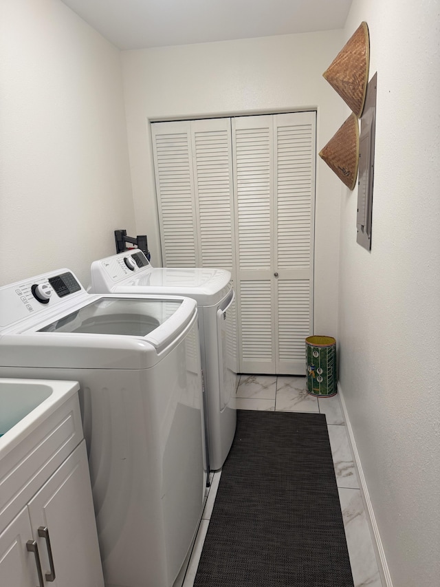 washroom with cabinets and independent washer and dryer