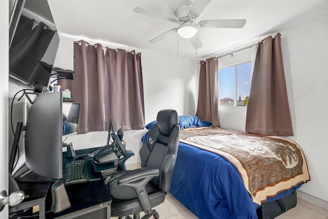 tiled bedroom featuring ceiling fan