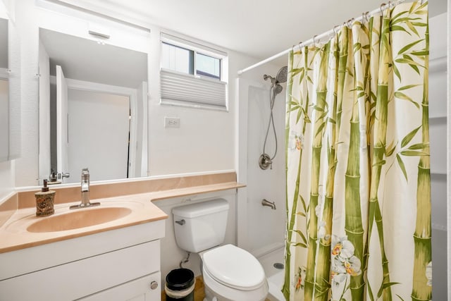 bathroom with curtained shower, vanity, and toilet