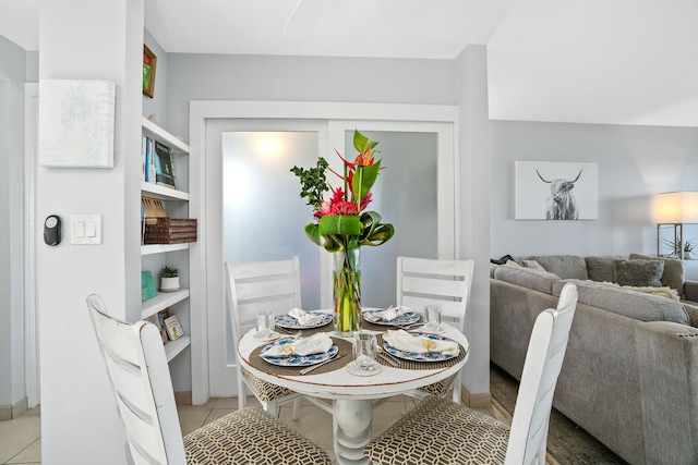 tiled dining space with built in shelves