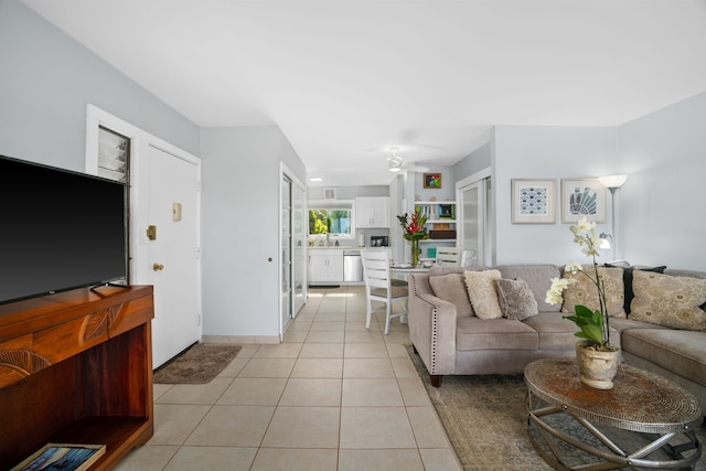 tiled living room featuring ceiling fan and sink