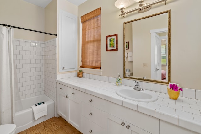 bathroom with vanity, hardwood / wood-style flooring, and shower / bath combo with shower curtain