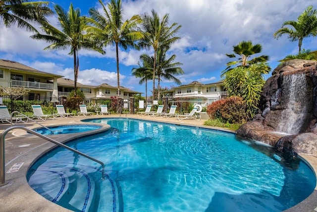 view of pool featuring pool water feature and a community hot tub