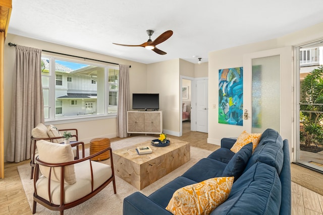 living room featuring ceiling fan and light hardwood / wood-style flooring