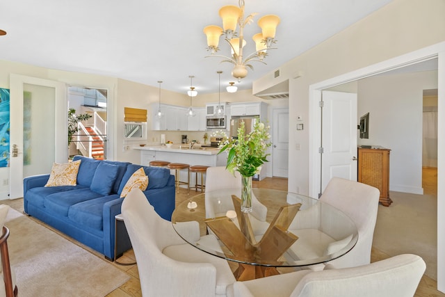 dining room featuring sink and a chandelier