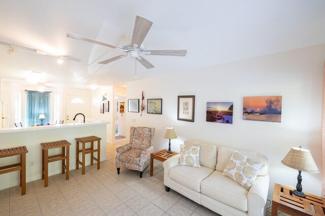 living room featuring rail lighting, ceiling fan, and light tile patterned flooring