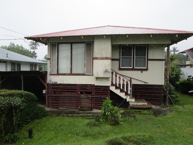 back of property with a lawn