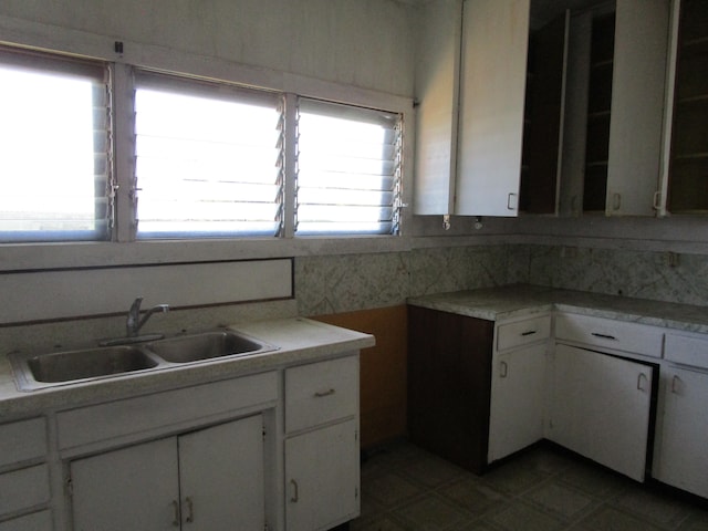 kitchen featuring white cabinetry and sink