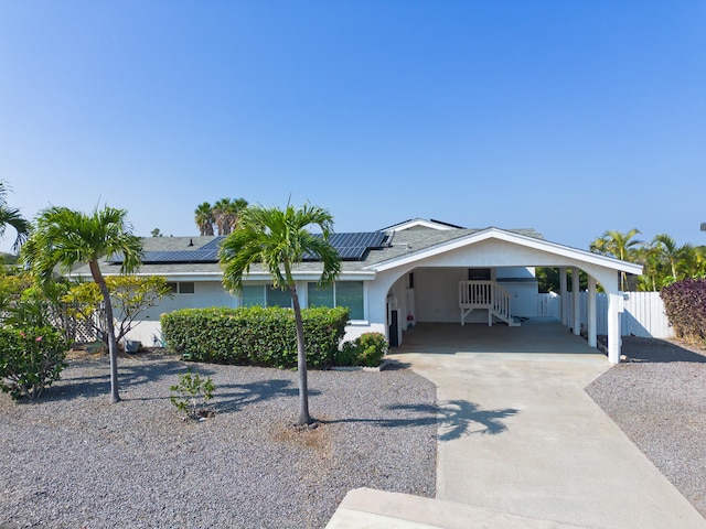 single story home with a carport and solar panels