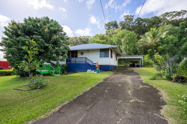 view of property exterior with a carport and a lawn