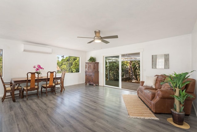 living room with ceiling fan, dark wood-type flooring, and an AC wall unit