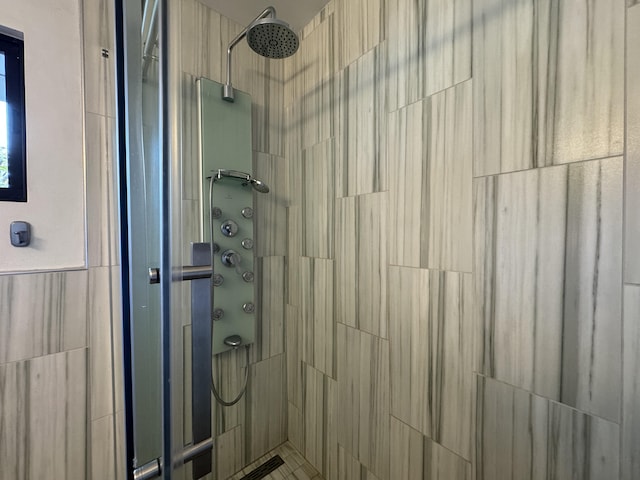 bathroom with tiled shower