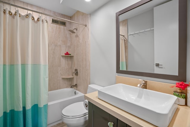 full bathroom with vanity, shower / bath combination with curtain, and toilet