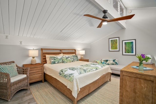 bedroom with vaulted ceiling with beams, light hardwood / wood-style floors, and ceiling fan