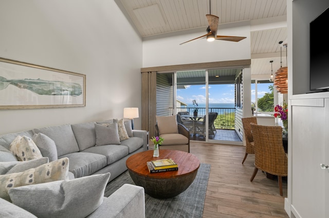 living room featuring lofted ceiling with beams, ceiling fan, hardwood / wood-style floors, and wooden ceiling