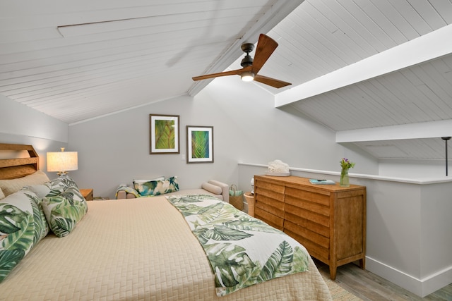 bedroom featuring vaulted ceiling with beams, ceiling fan, light wood-type flooring, and wooden ceiling